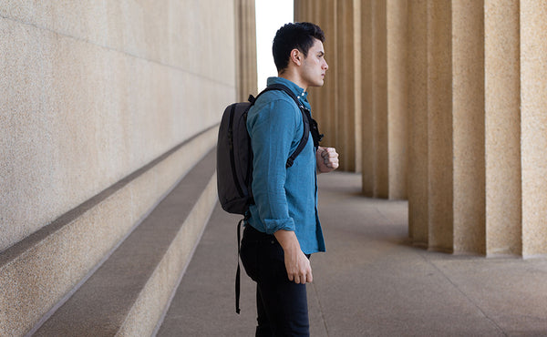 A profile shot of a person carrying the Luminary 15 via the backpack straps